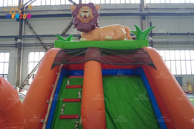 Inflatable dry slide with safety wall and jungle theme design