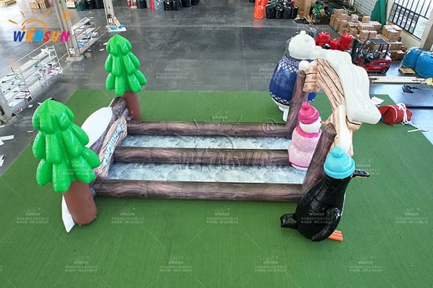 Festive winter inflatable bowling game with penguin figure