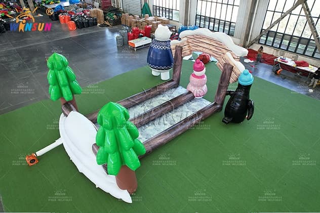 Large inflatable polar bear in blue sweater bowling attraction